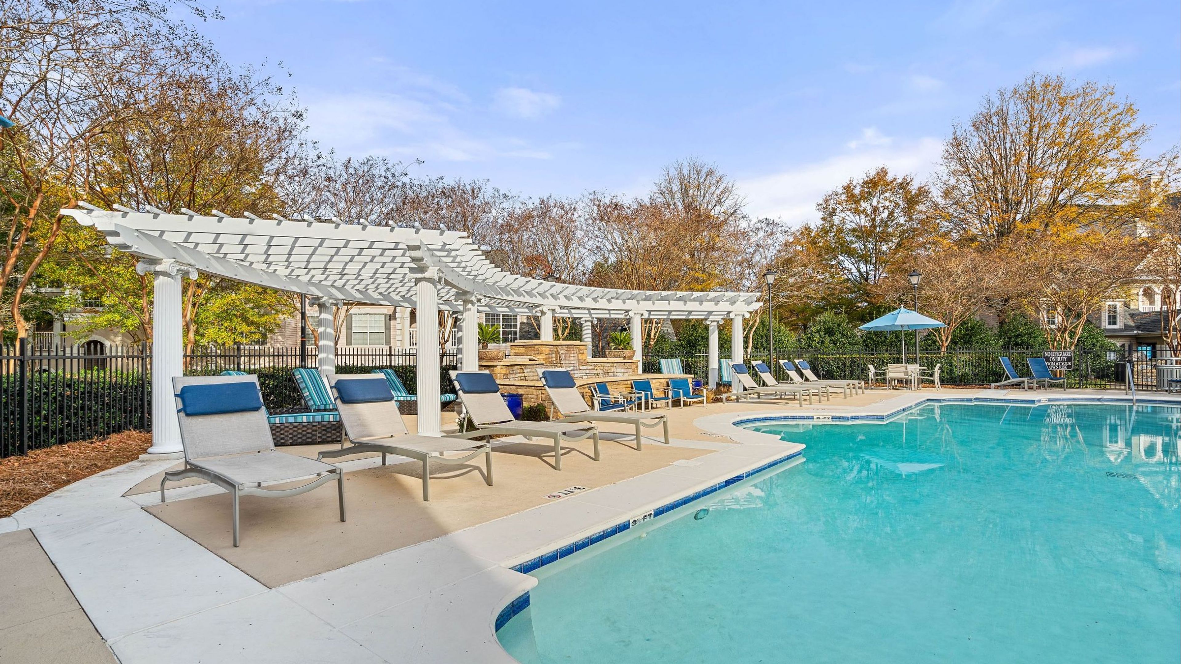 Hawthorne at the Carlyle resident pool with lounge chairs under a beautiful semi-shaded awning.